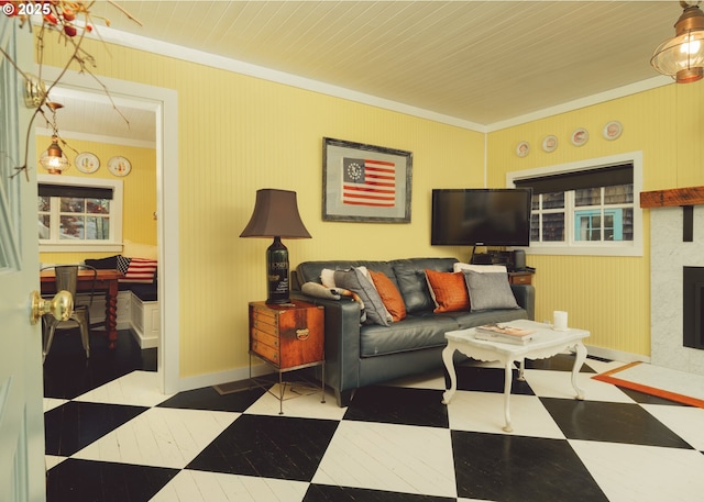762 G St, Gearhart, OR 97138 - living room with crown molding, tile patterned floors, and a fireplace