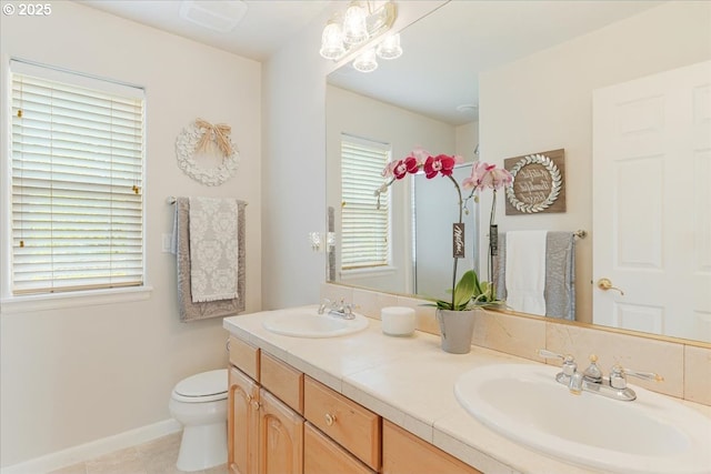 5711 SE Vista Ct, Milwaukie, OR 97267 - full bathroom with double vanity, toilet, baseboards, and tile patterned flooring