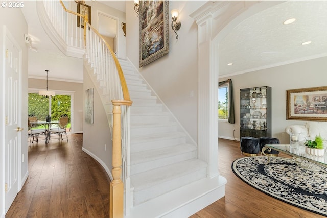 5711 SE Vista Ct, Milwaukie, OR 97267 - stairs featuring wood-type flooring, baseboards, crown molding, and recessed lighting