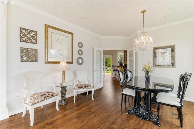 5711 SE Vista Ct, Milwaukie, OR 97267 - dining area with a chandelier, wood finished floors, crown molding, baseboards, and a textured ceiling