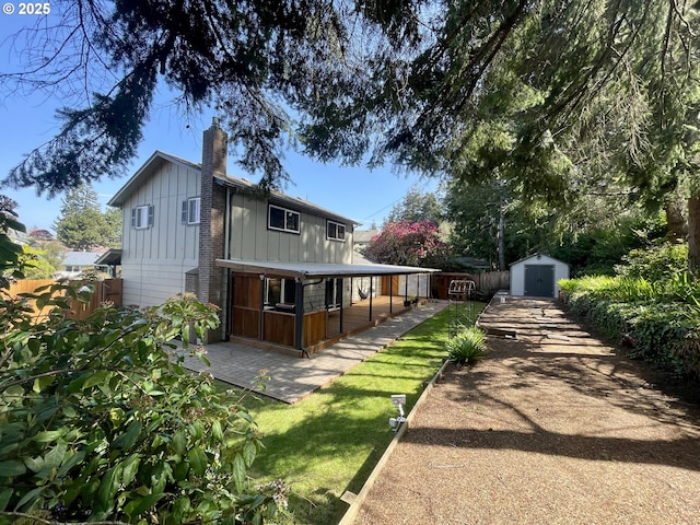 3851 Edgewood Dr, North Bend, OR 97459 - back of house featuring board and batten siding and a chimney