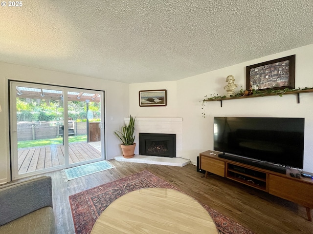3851 Edgewood Dr, North Bend, OR 97459 - living area featuring a fireplace, wood finished floors, and a textured ceiling