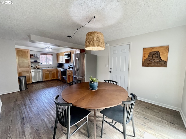 3851 Edgewood Dr, North Bend, OR 97459 - dining space featuring dark wood-type flooring, a textured ceiling, and baseboards