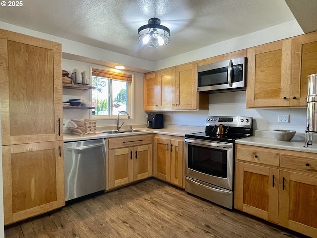 3851 Edgewood Dr, North Bend, OR 97459 - kitchen featuring stainless steel appliances, a sink, light countertops, wood finished floors, and open shelves