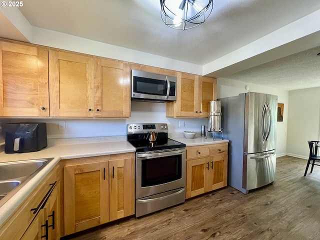 3851 Edgewood Dr, North Bend, OR 97459 - kitchen featuring stainless steel appliances, dark wood-style floors, light countertops, and a sink