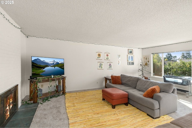 living room featuring a brick fireplace and a textured ceiling