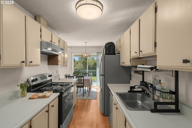 kitchen featuring stainless steel electric range oven, a sink, light countertops, a textured ceiling, and under cabinet range hood
