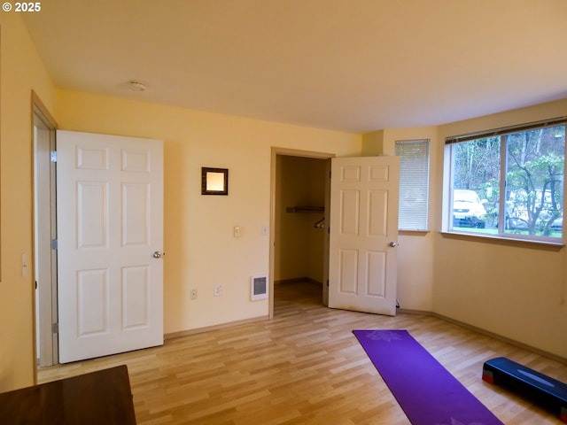 5142 SW Multnomah Blvd Unit A, Portland, OR 97219 - exercise area with visible vents, light wood-type flooring, and baseboards
