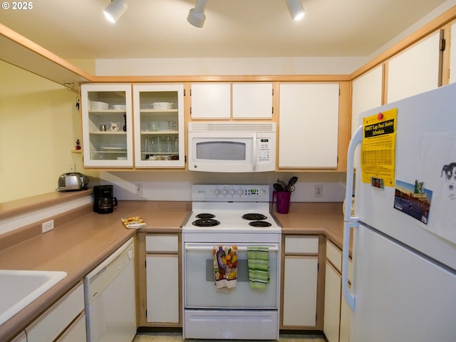 5142 SW Multnomah Blvd Unit A, Portland, OR 97219 - kitchen with white appliances, a sink, light countertops, glass insert cabinets, and white cabinetry