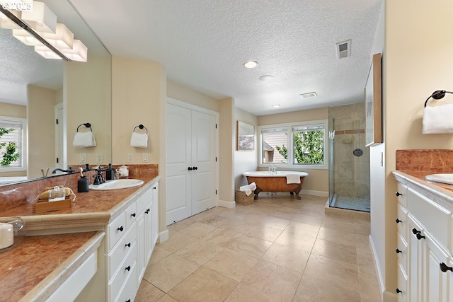 4055 NW Twilight Ter, Portland, OR 97229 - bathroom with vanity, a freestanding bath, a shower stall, a textured ceiling, and baseboards
