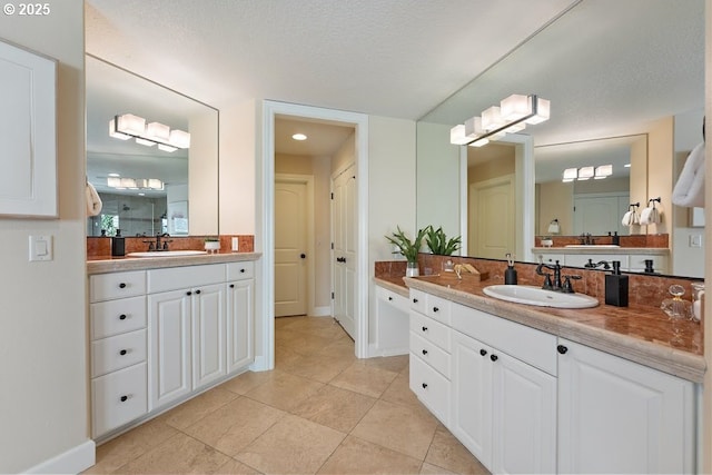 4055 NW Twilight Ter, Portland, OR 97229 - bathroom featuring two vanities, tile patterned floors, and baseboards