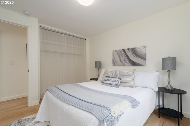 bedroom featuring light wood-type flooring and a closet