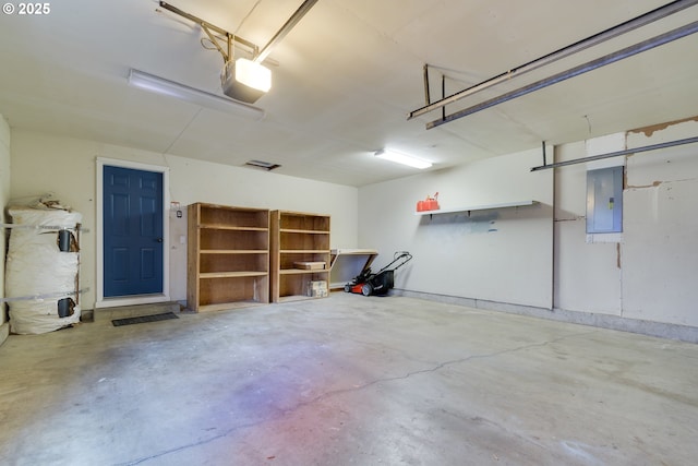 garage featuring a garage door opener and electric panel