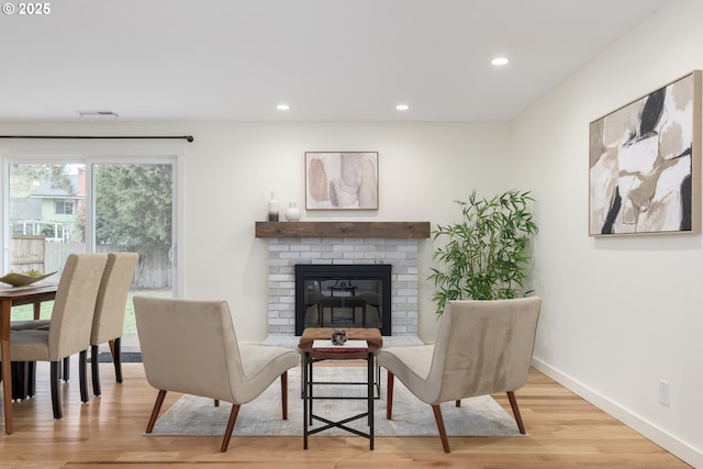 living area featuring a fireplace and light hardwood / wood-style floors