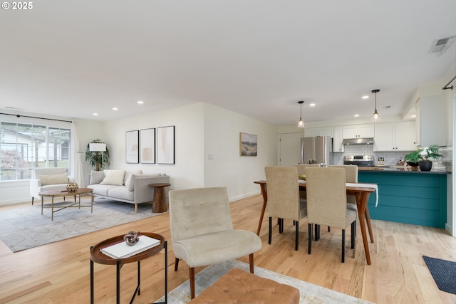 dining area featuring light wood-type flooring