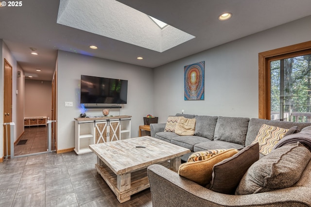 living area with recessed lighting, baseboards, and a skylight