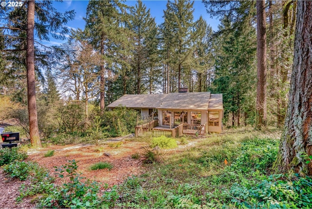 2592 Hillcrest Ct, West Linn, OR 97068 - rustic home featuring a deck, a wooded view, and a chimney