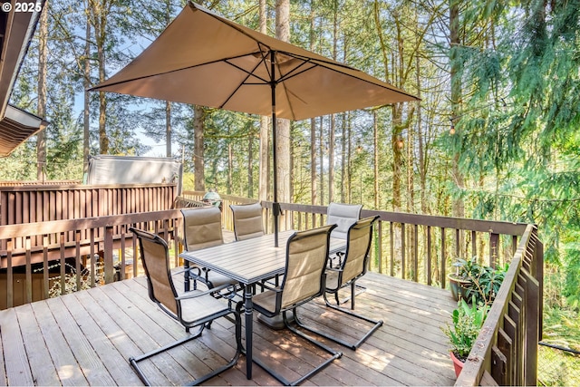 wooden deck featuring outdoor dining area