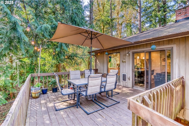 wooden terrace with outdoor dining space