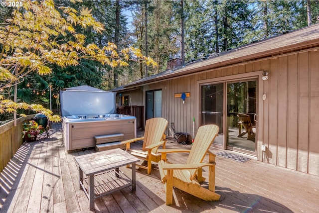 wooden deck with a hot tub