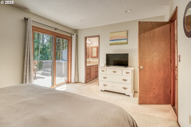 bedroom with light colored carpet, access to outside, a textured ceiling, connected bathroom, and recessed lighting