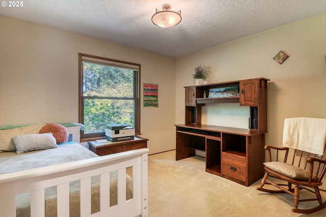 bedroom featuring a textured ceiling and light colored carpet