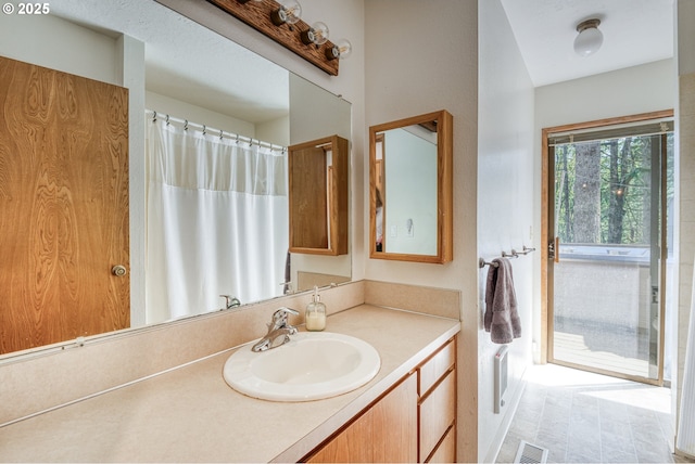 full bathroom with vanity and visible vents