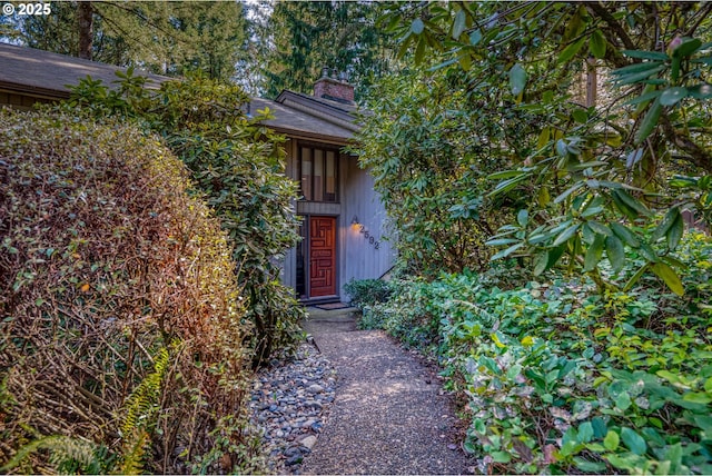 doorway to property with a chimney