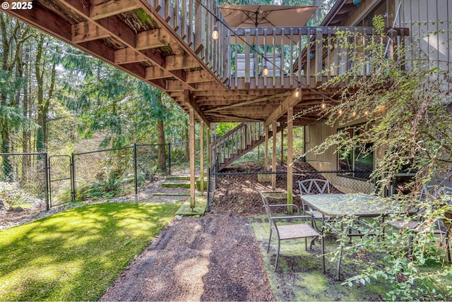 view of yard featuring fence, a gate, stairs, and a deck