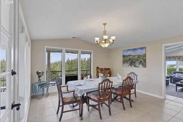 dining area featuring visible vents, lofted ceiling, an inviting chandelier, light tile patterned flooring, and baseboards