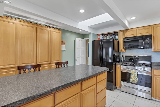 kitchen featuring light tile patterned floors, dark countertops, black appliances, and recessed lighting