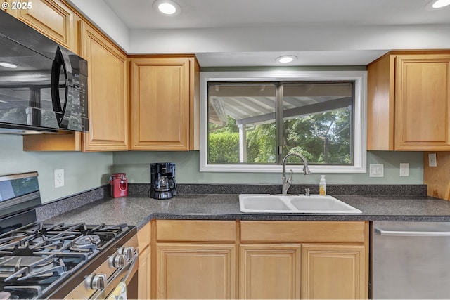 kitchen featuring a sink, dark countertops, recessed lighting, and stainless steel appliances