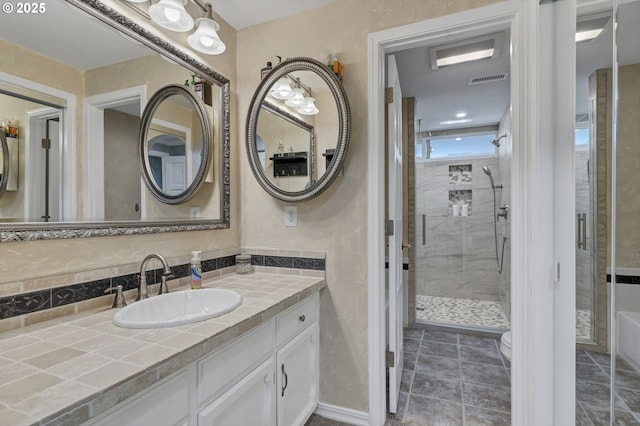 full bath featuring vanity, a shower stall, and tile patterned floors