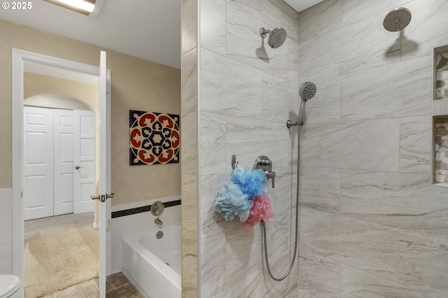 full bathroom with a bathing tub and tiled shower