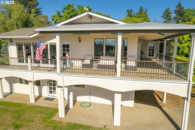 back of house featuring stucco siding and a patio