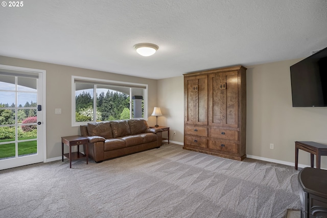 living room featuring light carpet, plenty of natural light, and baseboards