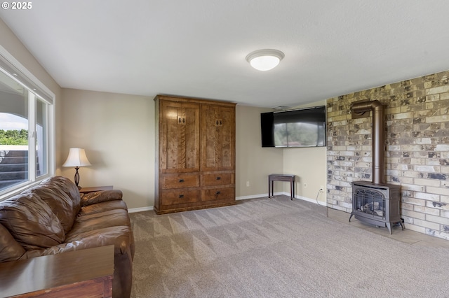 living room with a wood stove, baseboards, and carpet flooring