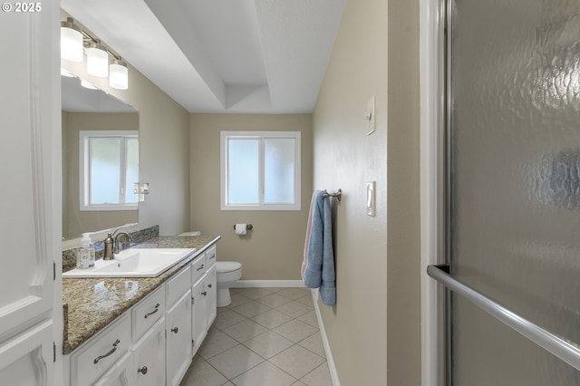 full bath featuring tile patterned floors, toilet, a healthy amount of sunlight, and baseboards