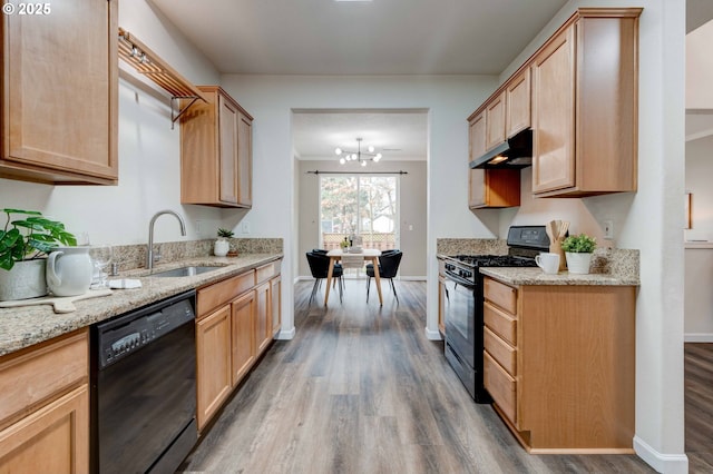 kitchen featuring wood-type flooring, light stone countertops, sink, and black appliances