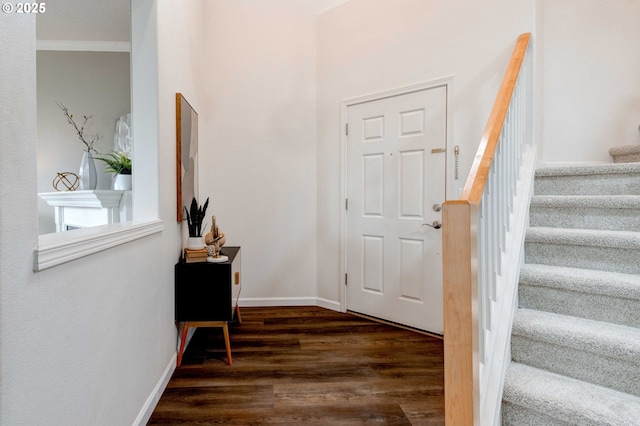 foyer entrance featuring ornamental molding and dark hardwood / wood-style flooring