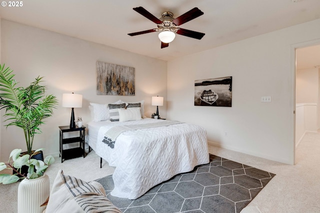 carpeted bedroom featuring ceiling fan and baseboards