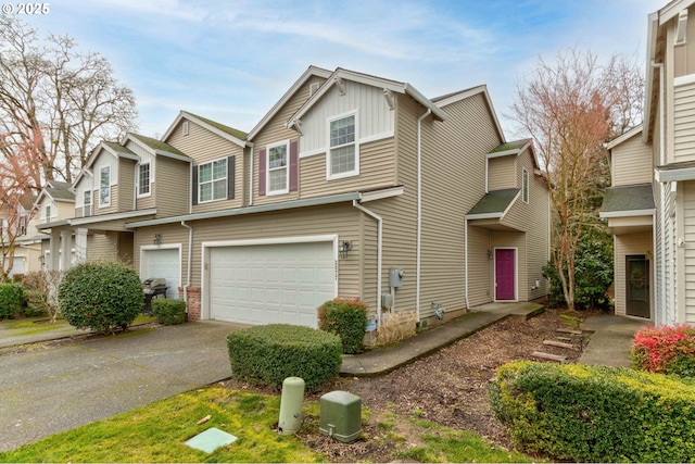 view of property with board and batten siding, brick siding, driveway, and an attached garage