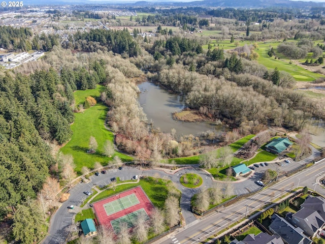 drone / aerial view with a wooded view