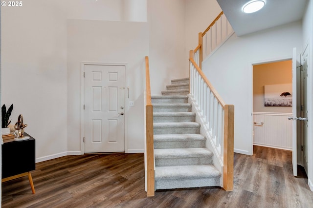 stairs featuring baseboards and wood finished floors