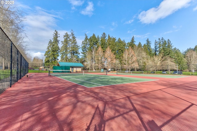 view of tennis court with fence