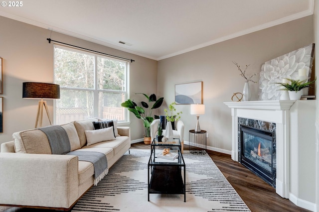 living room with a premium fireplace, ornamental molding, and dark hardwood / wood-style flooring