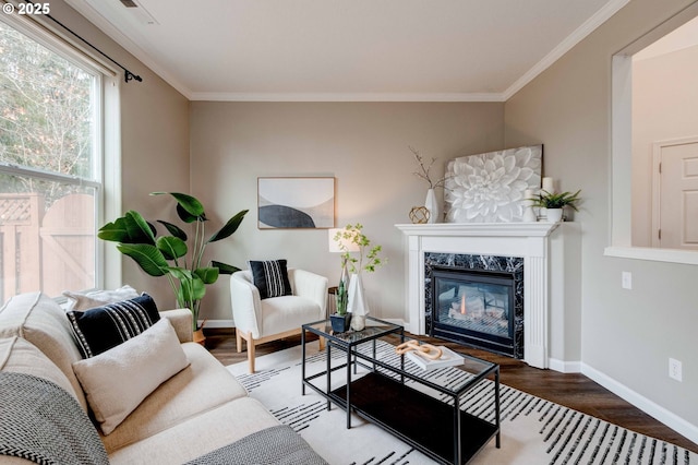 living room featuring crown molding, hardwood / wood-style flooring, and a high end fireplace