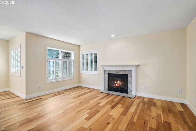 5364 Rosewood St, Lake Oswego, OR 97035 - unfurnished living room featuring wood finished floors, a tile fireplace, baseboards, a textured ceiling, and recessed lighting