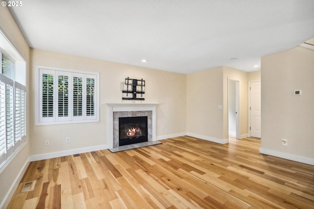 5364 Rosewood St, Lake Oswego, OR 97035 - unfurnished living room featuring light wood-style floors, baseboards, a high end fireplace, and recessed lighting