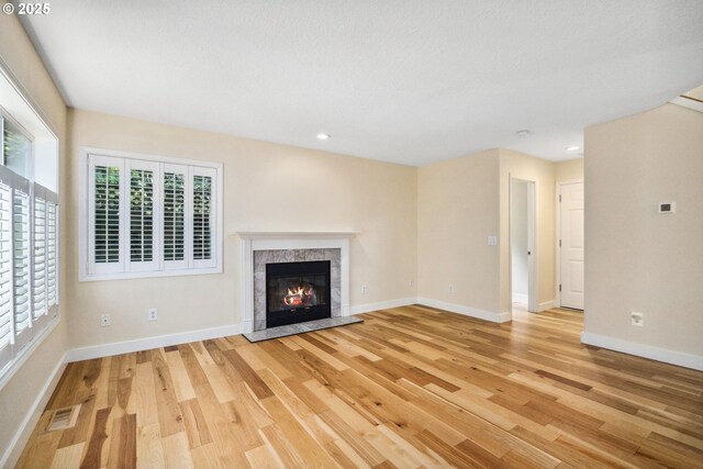 5364 Rosewood St, Lake Oswego, OR 97035 - unfurnished living room with light wood-type flooring, baseboards, a high end fireplace, and recessed lighting
